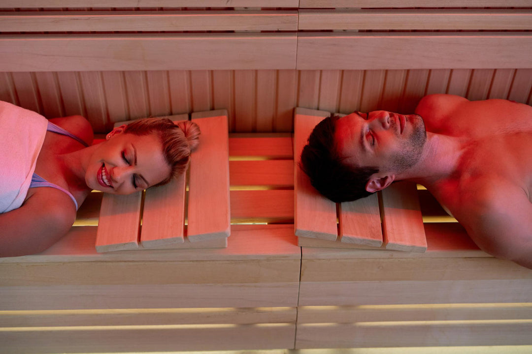 Vogelperspectief van een stel dat ontspant met hun ogen dicht terwijl ze in de sauna zijn